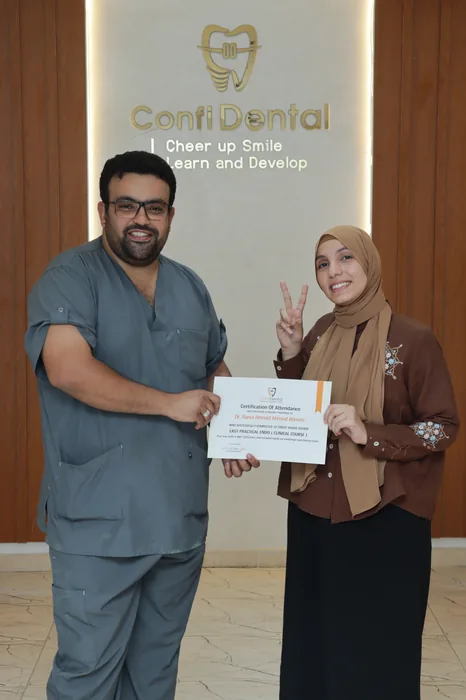 A graduate receiving their certificate of attendance at ConfiDental